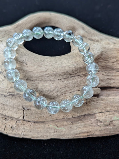 Close-up of 9mm Green Amethyst (Prasiolite) Bracelet, showing high-clarity quartz and internal structure.