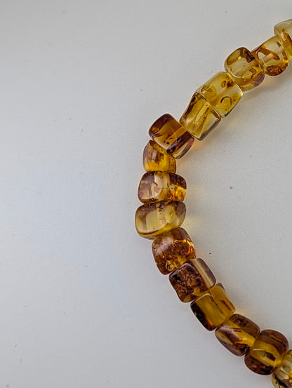 Close-up of Baltic Amber Bracelet 5.5 mm showing barrel-cut beads and transparency