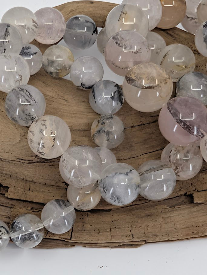 Dendritic quartz bracelet highlighting high-clarity beads with bold dendrite structures.