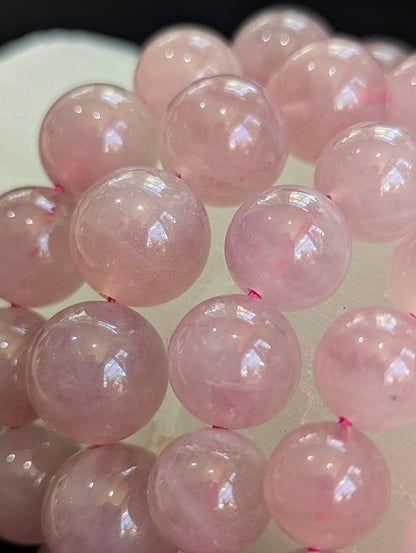 Closeup of collection of 7mm, 8mm, 9mm, 10mm, 11mm, 12mm and 13mm Lavender Rose Quartz Bracelets