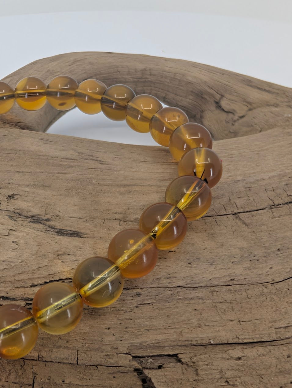 Closeup of 6mm Mexican blue amber beads showing honey cognac colour