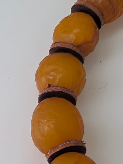 Close-up of Old Russian Amber Bracelet 8mm – visible inclusions, natural surface texture, and aged patina
