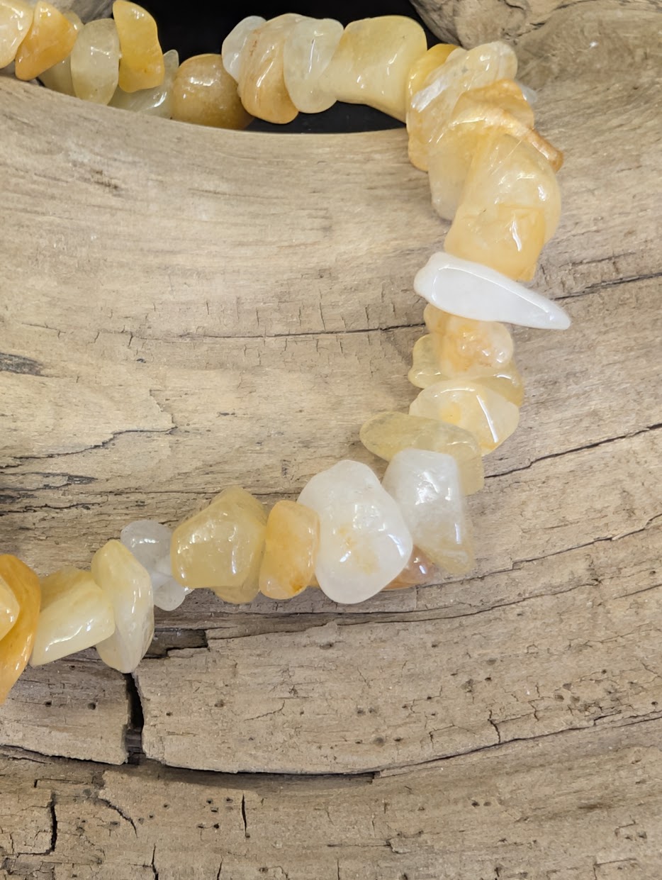 Close-up of polished Yellow Aventurine chips showing variations in golden-yellow translucency and honey-toned color.