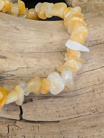 Close-up of polished Yellow Aventurine chips showing variations in golden-yellow translucency and honey-toned color.