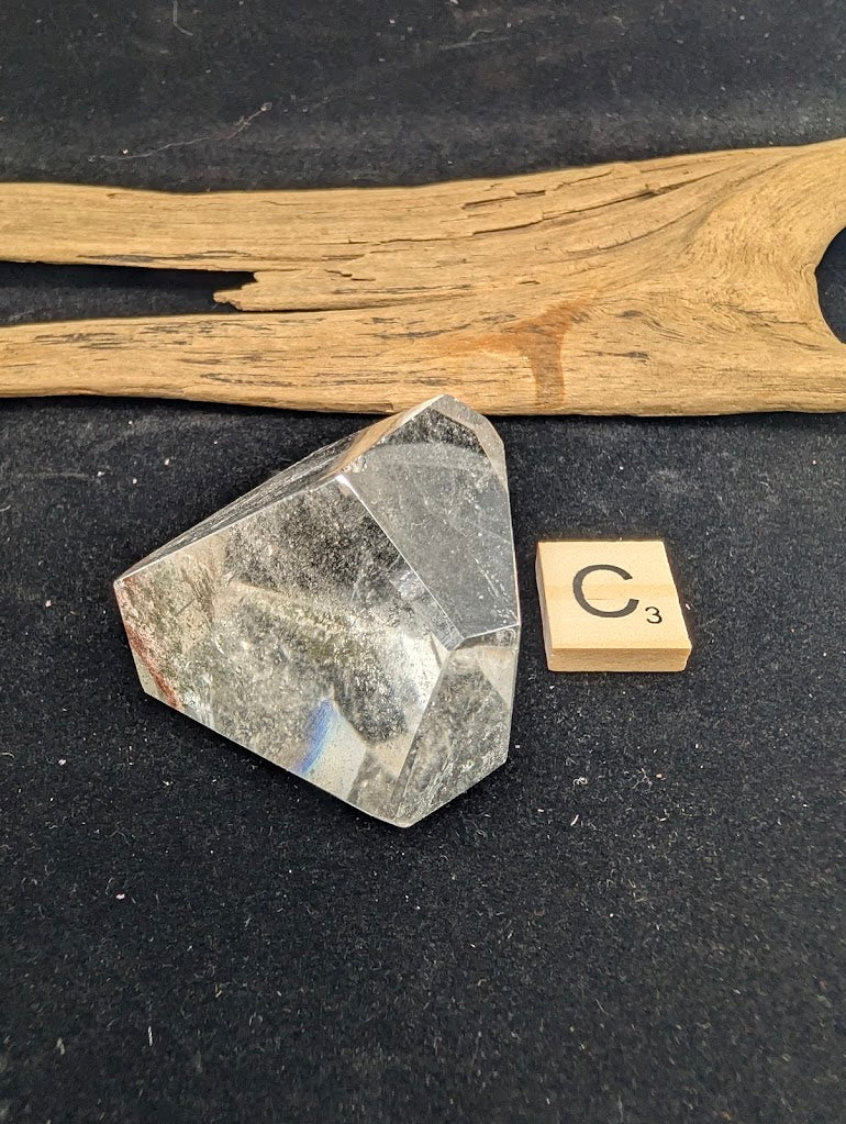 Exact piece Garden Quartz faceted freeform, Variant C3, displaying high clarity quartz with a localized inclusion cluster anchored near the base.
