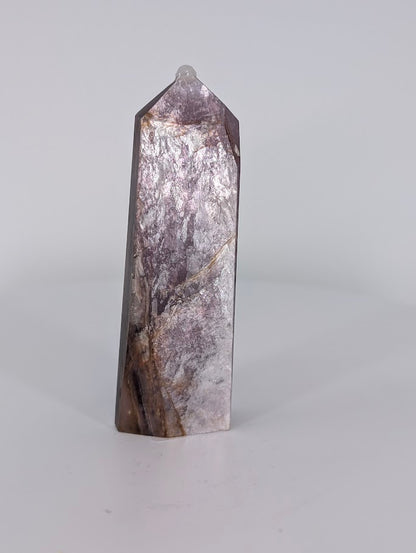 Angled view of Purple Mica Tower highlighting layered mica sheets and golden undertones.
