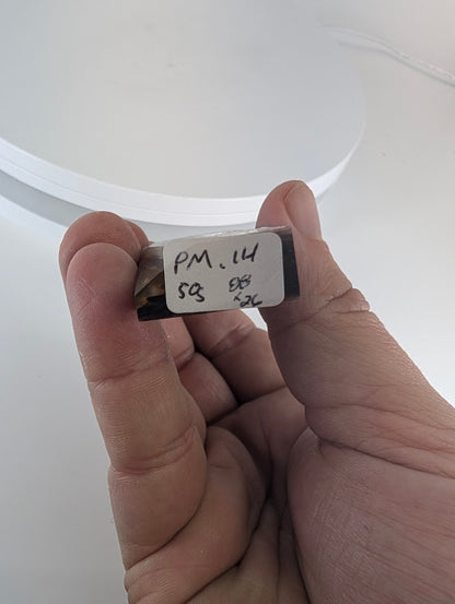 Base view of Purple Mica Tower showing handwritten label PM-14 – specimen from Madagascar.