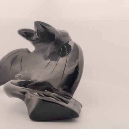 Rear view of Black Obsidian Toothless carving, polished tail and wings