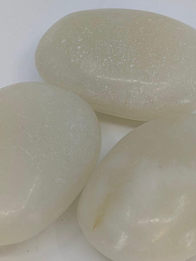 Afghan Jade palm stones close-up showing creamy white surface and natural pearly sheen