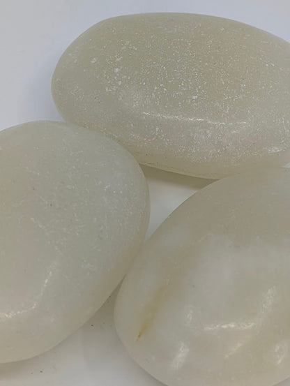 Afghan Jade palm stones close-up showing creamy white surface and natural pearly sheen