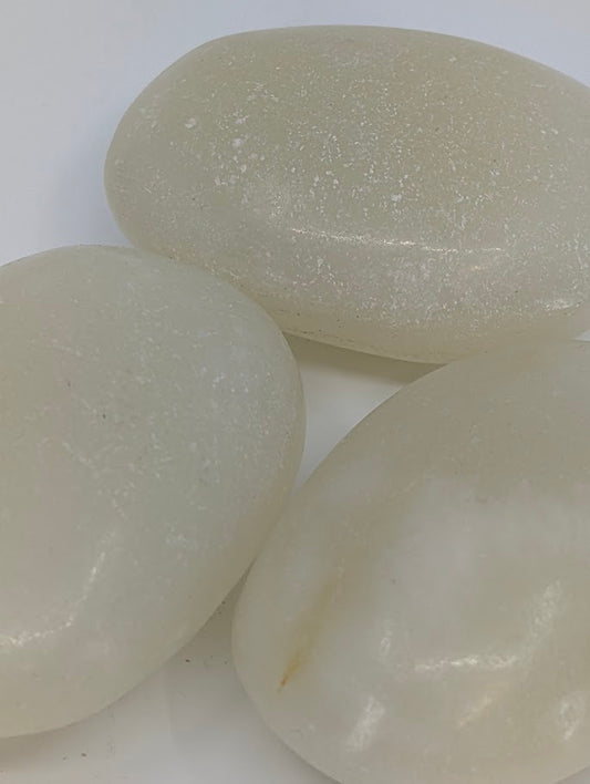Afghan Jade palm stones close-up showing creamy white surface and natural pearly sheen