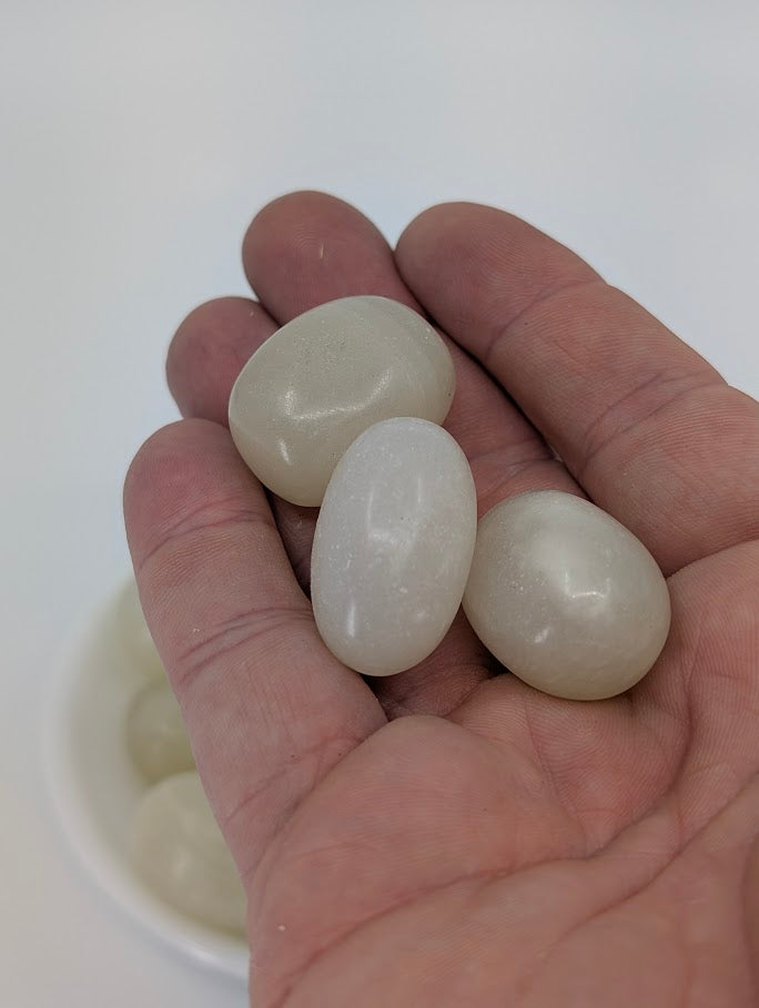 Afghan Jade tumbled stones shown in hand for scale