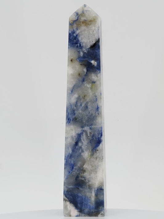 A 4.25-inch Afghanite tower from Afghanistan weighing 240g with a blue identification tag, showing blue and white patterns.