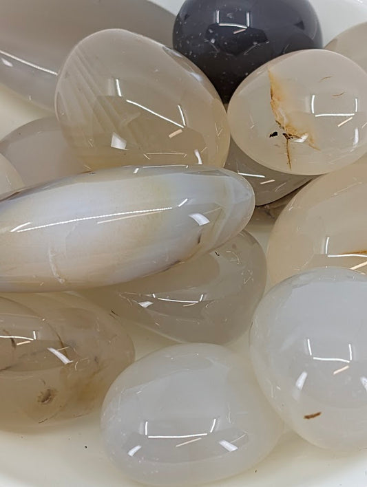 Close-up of agate tumbled stones showing translucent banding