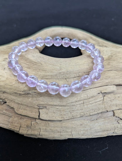 7mm High Quality Brazilian Amethyst beaded stretch bracelet on driftwood, showing dainty lilac quartz beads.