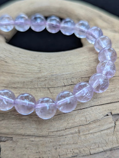 Macro shot of 7mm High Quality Brazilian Amethyst beads highlighting delicate lavender colouration and clear internal structure.