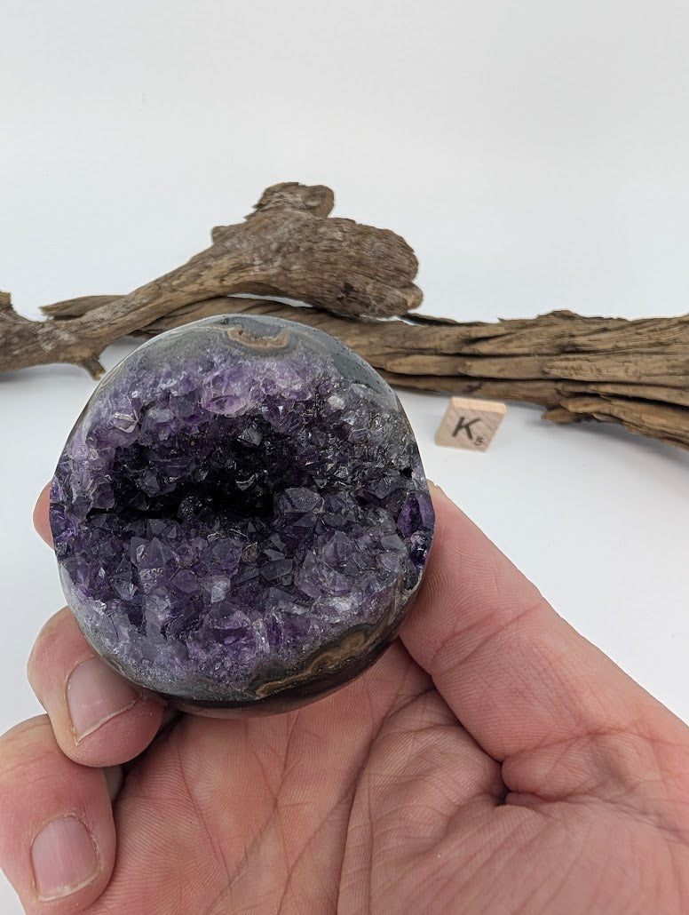 Hand-held view of compact Amethyst sphere Specimen K.