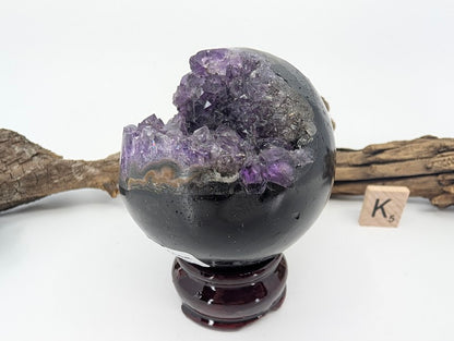 Angled view of Specimen K showing sharp crystal rim.