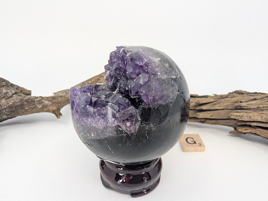 Front view of Amethyst sphere with wedge-shaped crystal vug (Specimen G).