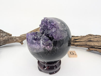 Front view of Amethyst sphere with wedge-shaped crystal vug (Specimen G).