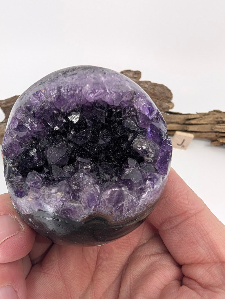 Close-up hand-held view of gemmy Amethyst sphere Specimen J.