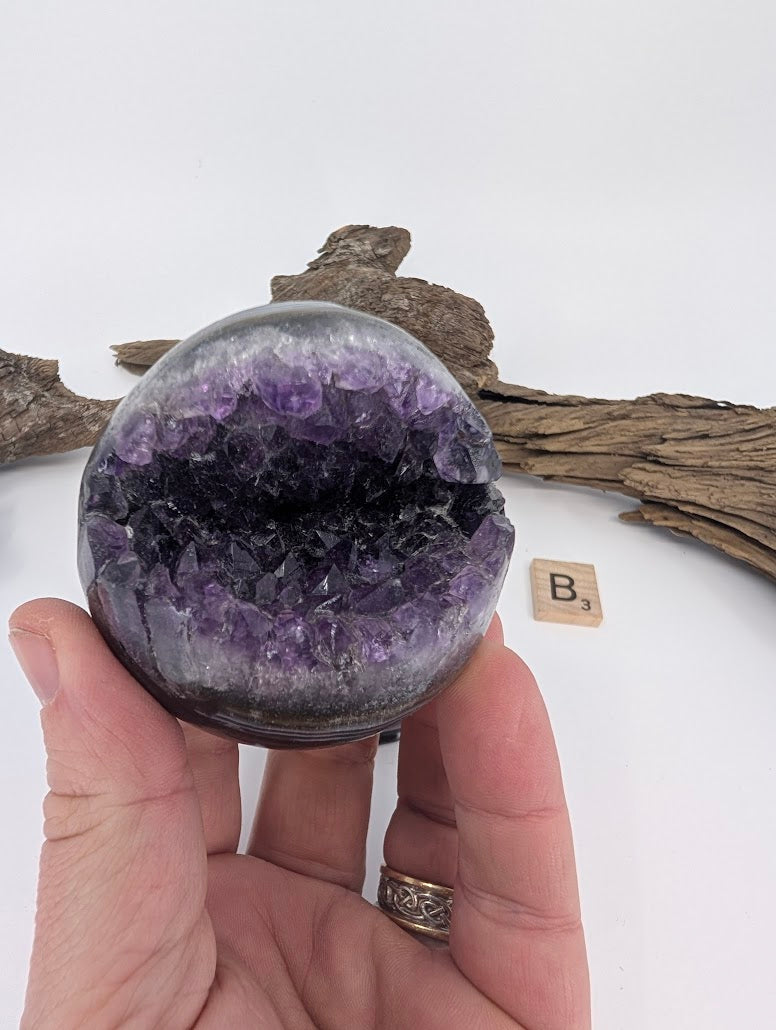Hand-held view of Amethyst sphere Specimen B showing relative size.