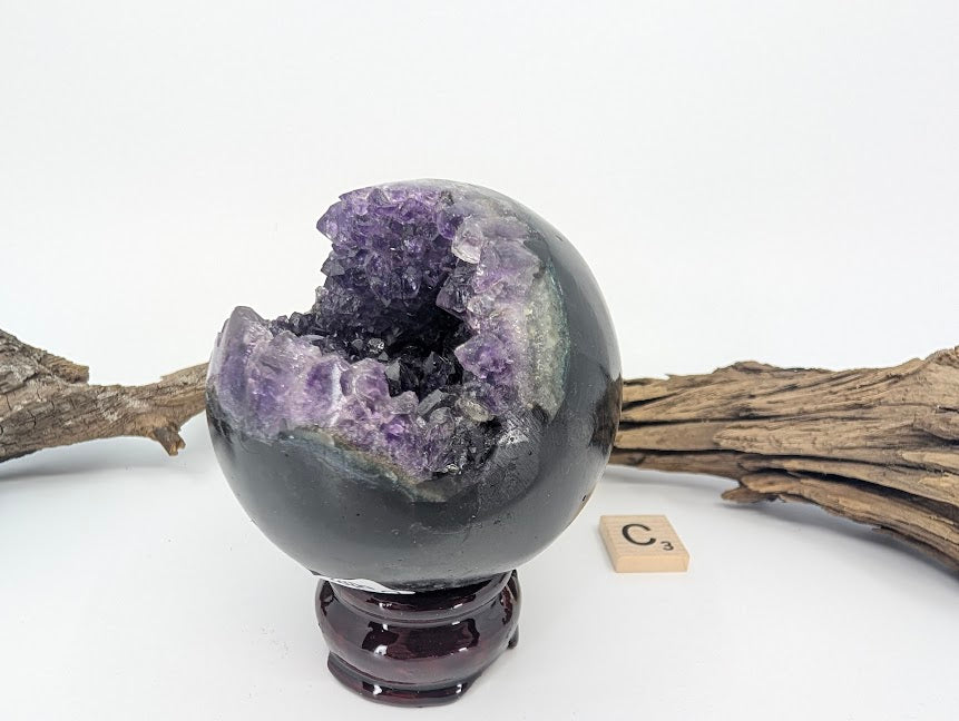 Angled close-up of intense purple crystals in Amethyst sphere (Specimen C).