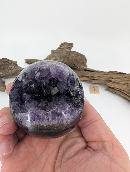 Hand-held view of large jagged Amethyst sphere Specimen I.