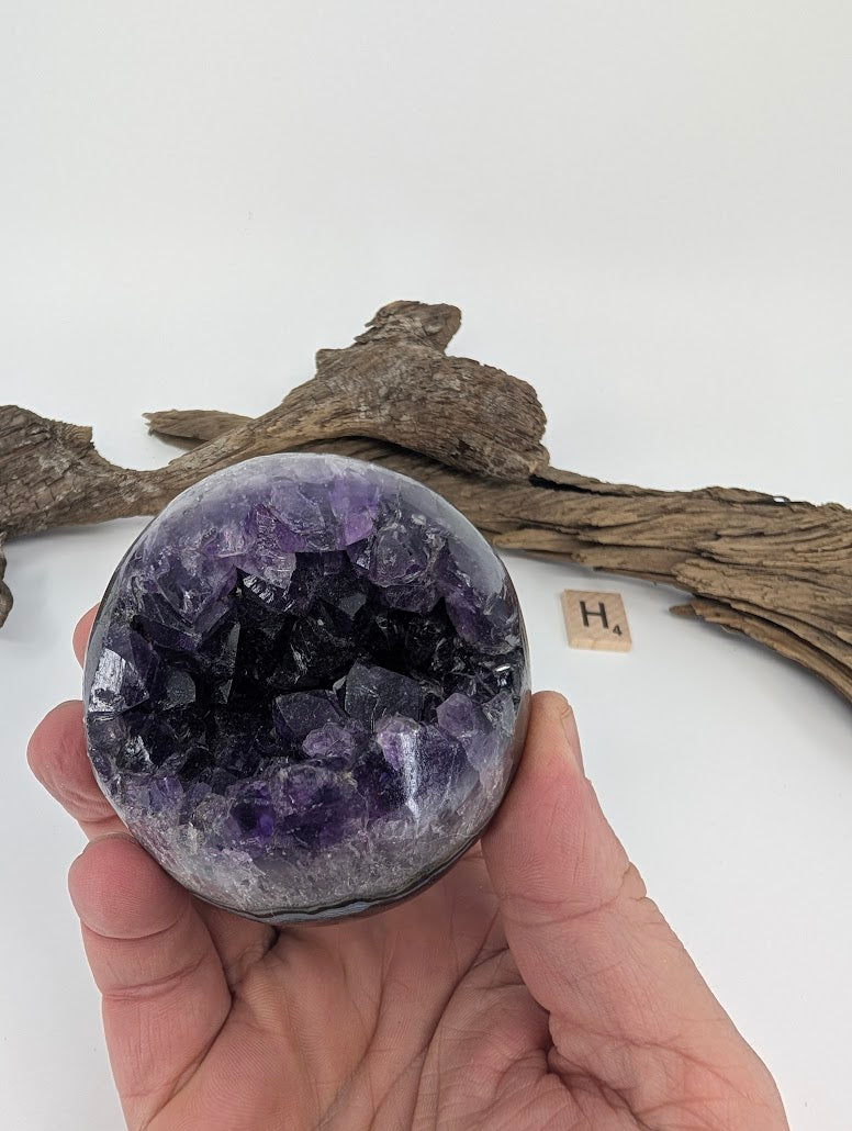 Hand-held view of heavy Amethyst sphere Specimen H.