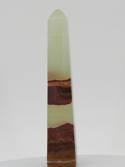Polished Banded Onyx (Banded Calcite) obelisk featuring high-translucency pistachio green layers and undulating rust-brown mineral bands.