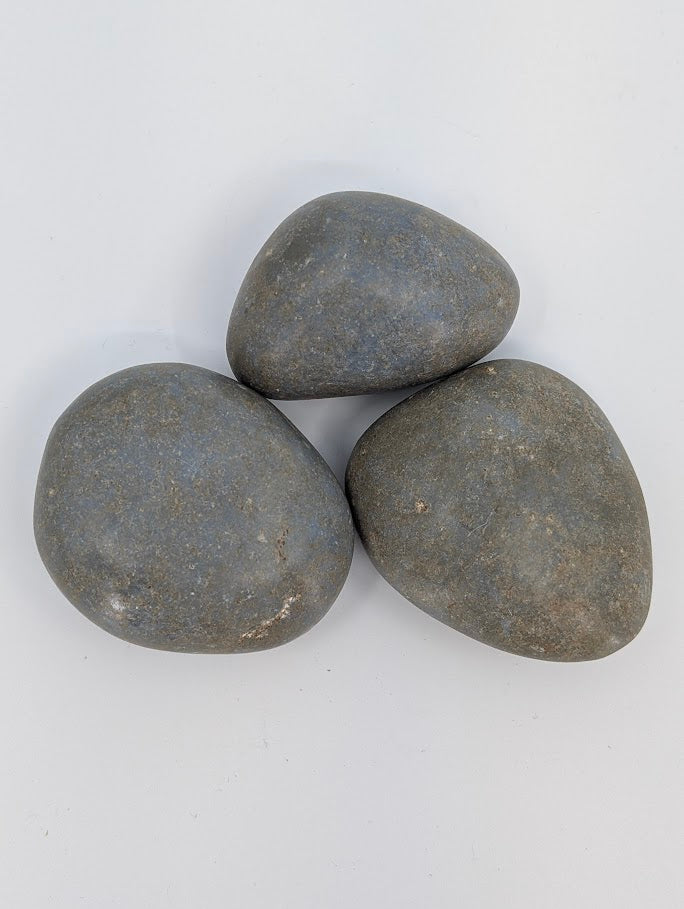 Angelite palm stones grouped together showing subtle texture and even blue tone