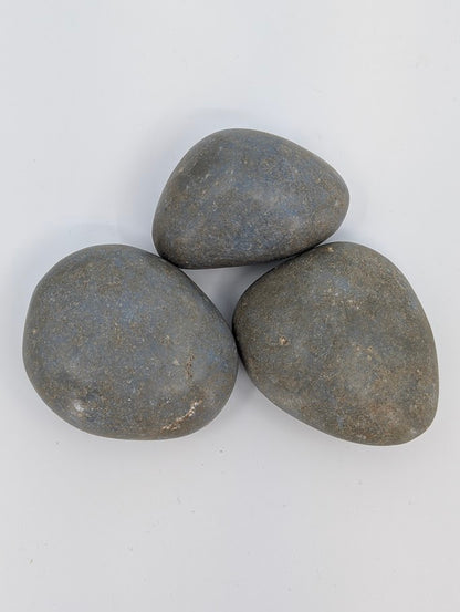 Angelite palm stones grouped together showing subtle texture and even blue tone