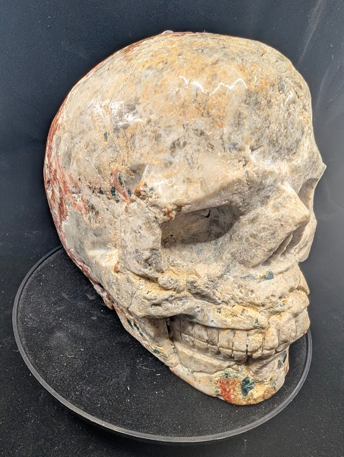 Three-quarter right view showing facial carving and mineral contrast
