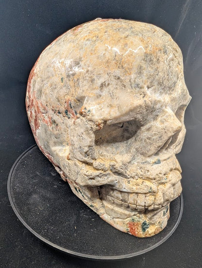 Three-quarter right view showing facial carving and mineral contrast