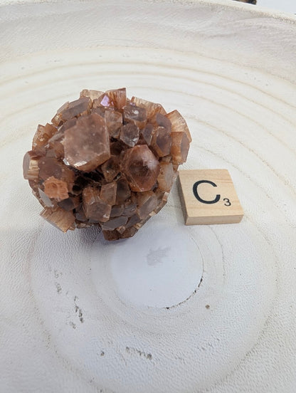 AA Grade Aragonite Star Cluster, 90g, featuring dense radial crystal growth and earthy tones.