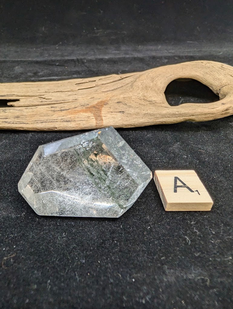 Exact piece Garden Quartz faceted freeform, showcasing delicate green chlorite moss-like inclusions within clear quartz.