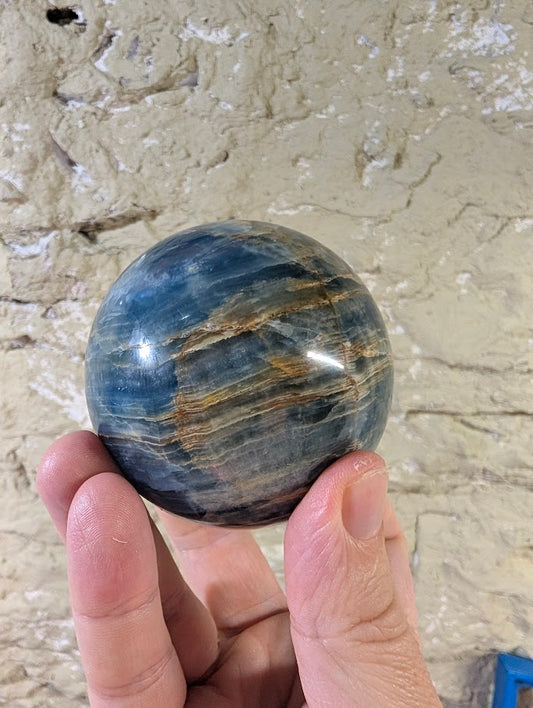 Side view of blue calcite sphere showing natural banding