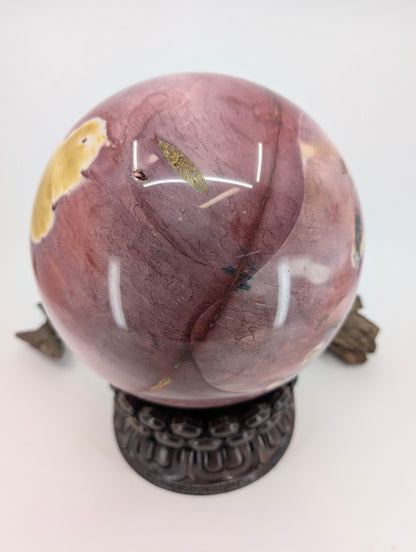 Side profile of an Australian Jasper sphere showing deep burgundy and lavender mineral banding.
