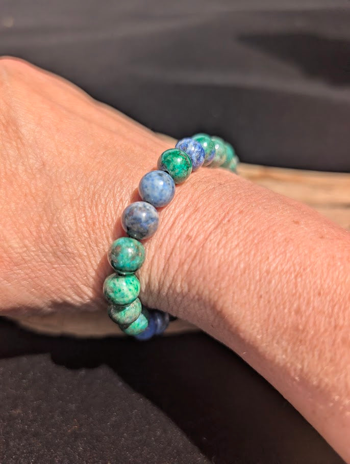 Natural sunlight on an 8mm Azurite-Malachite stretch bracelet worn on a wrist.