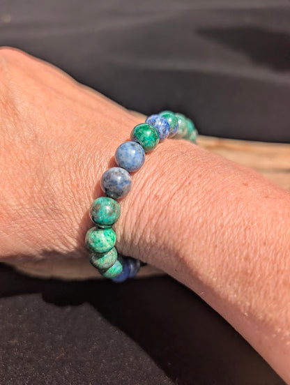 Natural sunlight on an 8mm Azurite-Malachite stretch bracelet worn on a wrist.