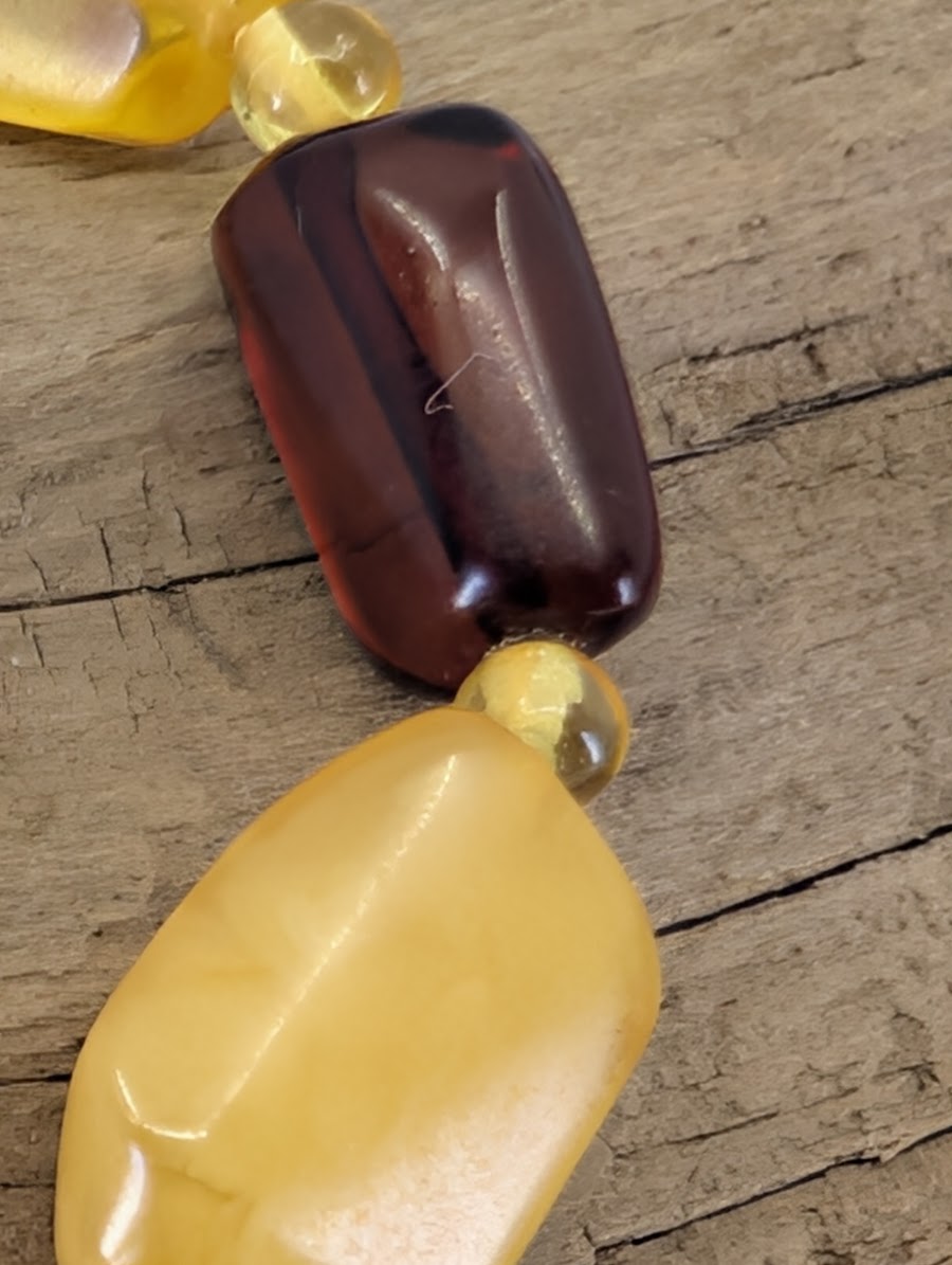 Macro view of a cognac Baltic Amber bead showing natural internal textures and high-gloss fossilized resin luster