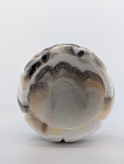 Banded calcite pumpkin carving – bottom view showing natural banding