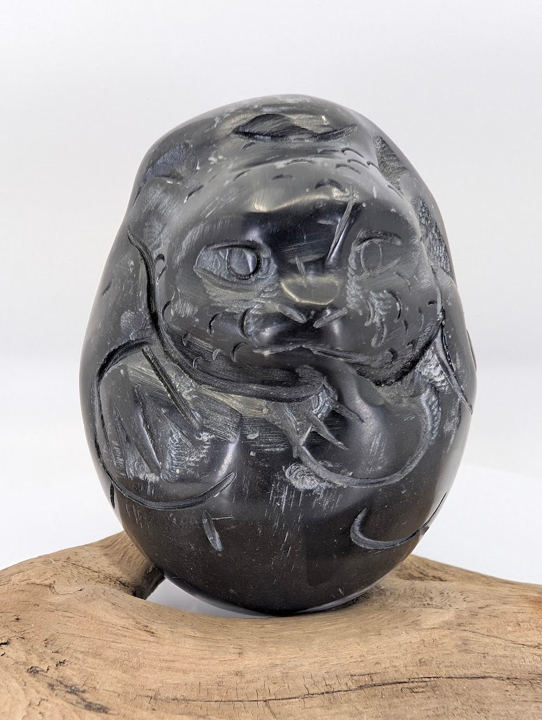 Frontal view of the Black Chu Stone Dragon's face, highlighting the prominent eyes and traditional whiskers.