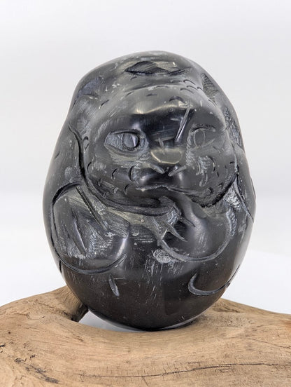 Frontal view of the Black Chu Stone Dragon's face, highlighting the prominent eyes and traditional whiskers.