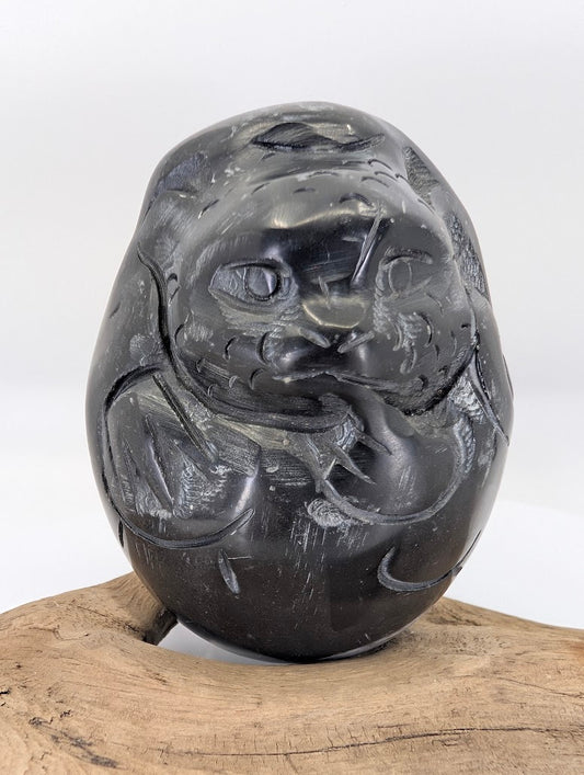 Frontal view of the Black Chu Stone Dragon's face, highlighting the prominent eyes and traditional whiskers.