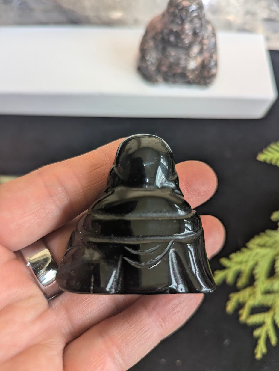 Back view of a Black Obsidian Laughing Buddha carving showing the uniform opaque black color and flawless polished surface.