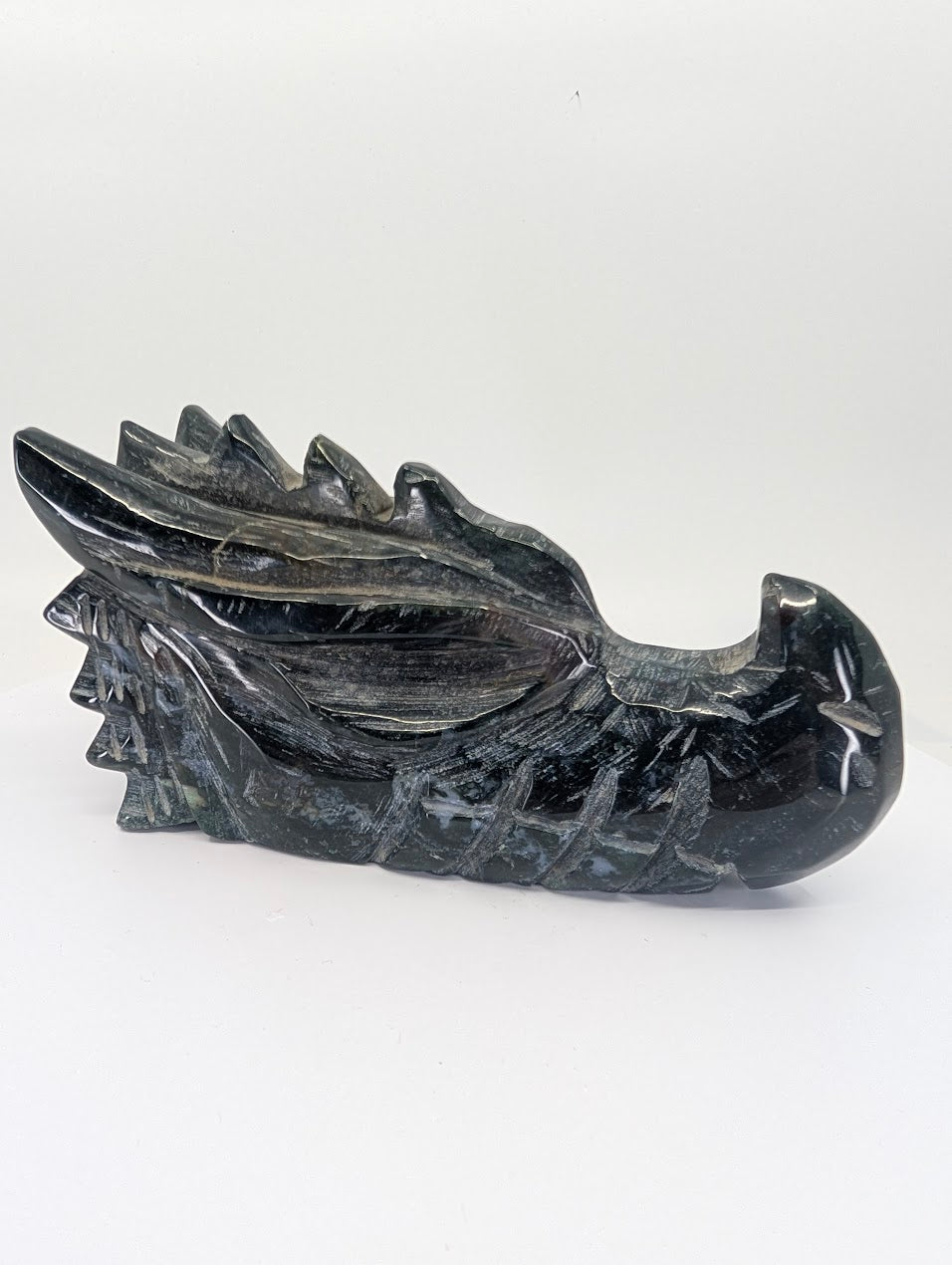 Front view of black obsidian dragon head carving, 795g, 14.5 × 7 × 8 cm