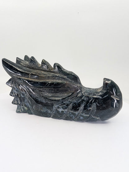 Front view of black obsidian dragon head carving, 795g, 14.5 × 7 × 8 cm