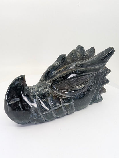 Side profile of black obsidian dragon head showing polished detail