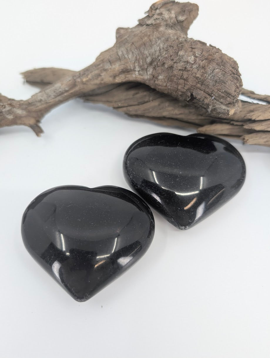 Pair of solid Black Obsidian hearts showing high gloss polish.